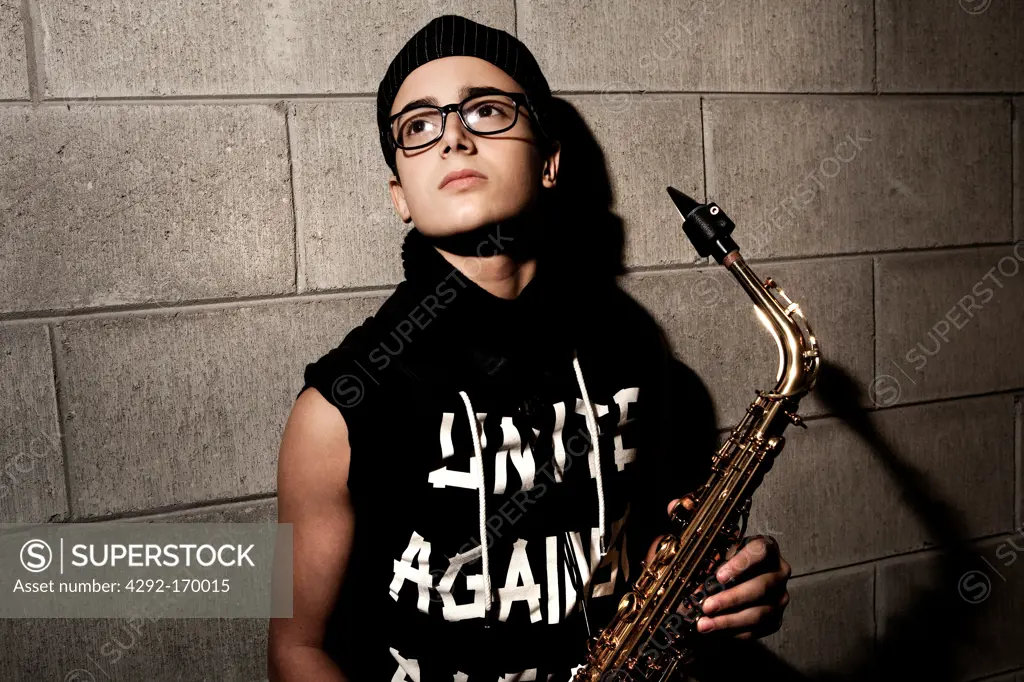 Teenaged boy playing saxophone
