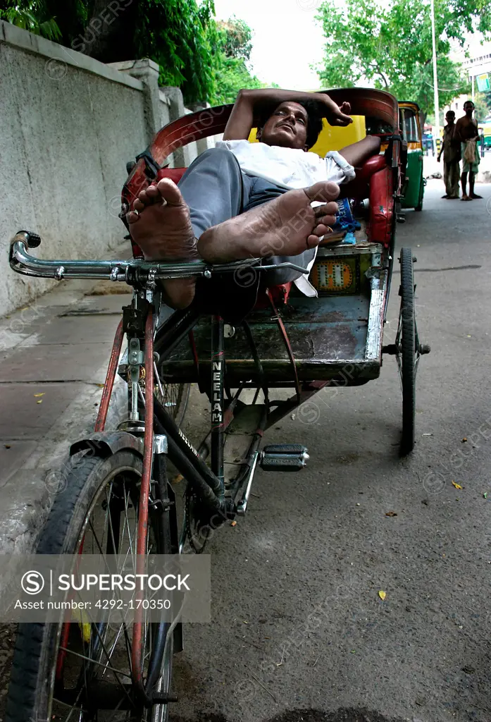 India, rickshaw driver resting