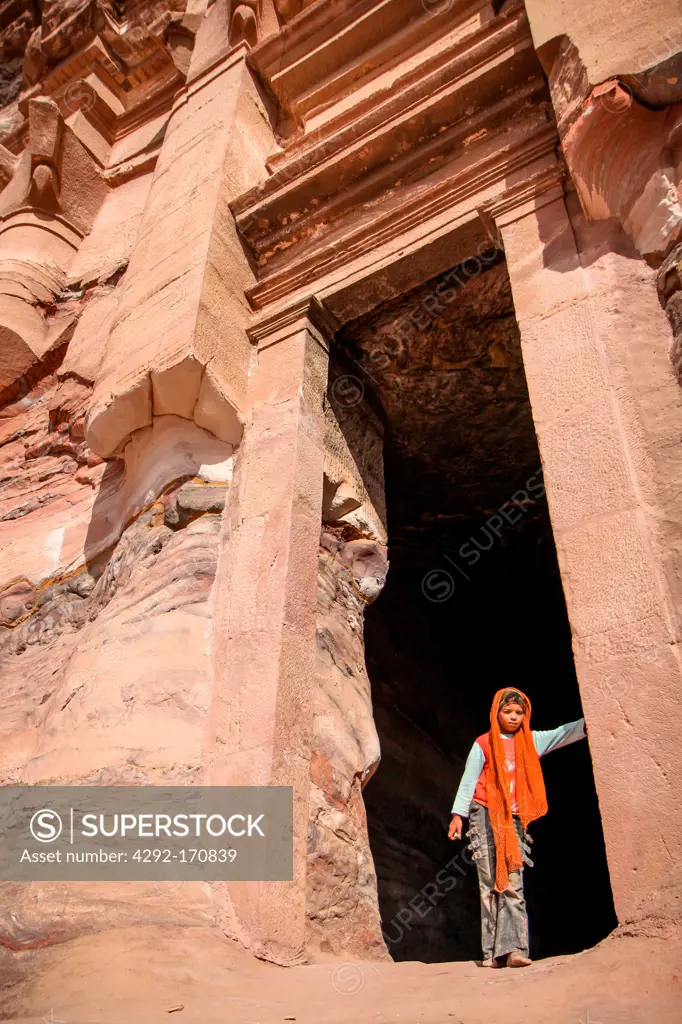 Jordan, Middle East, Petra, Girl between tomb's gate