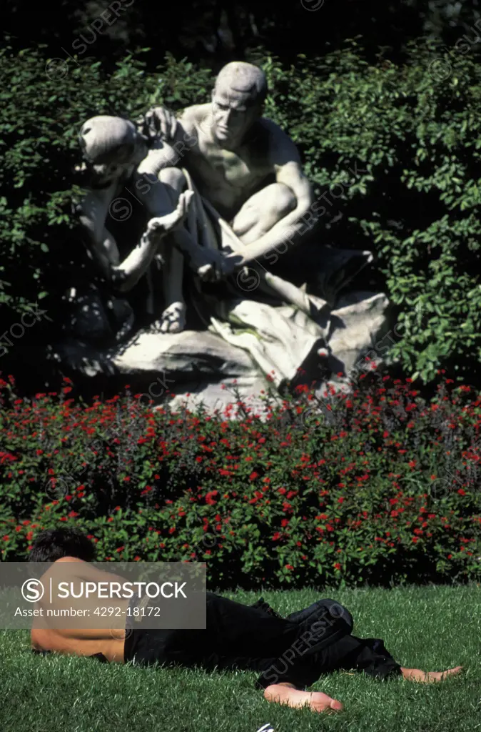 Argentina, Buenos Aires: man lying on the grass in Plaza Dorrego