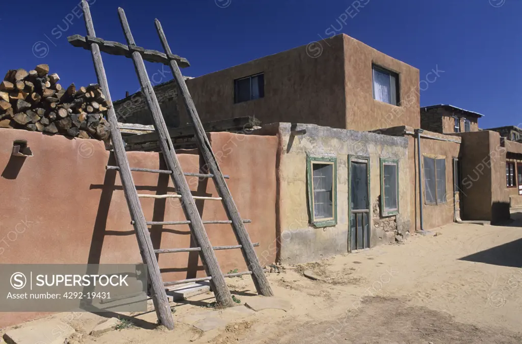 New Mexico, Acoma Indian Reservation, Acomo pueblo with ladders leading to roof tops
