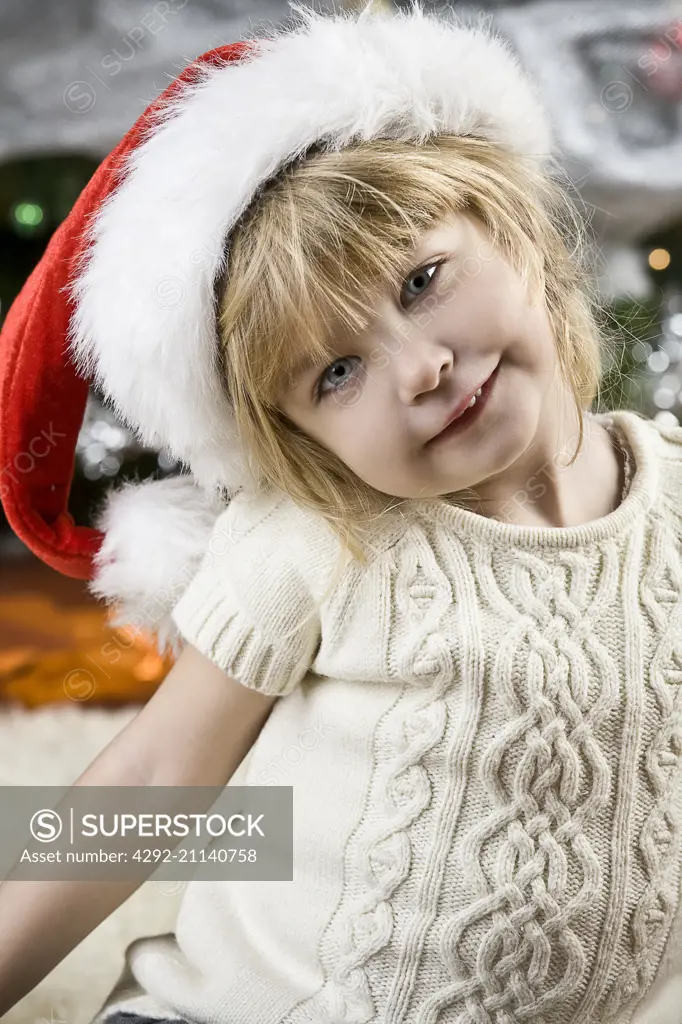 little girl wearing santa claus hat