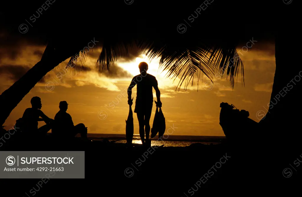 Seychelles, fisherman at sunset