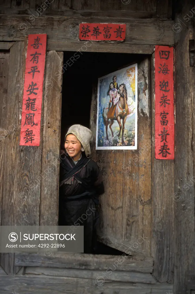 Miao woman on door step