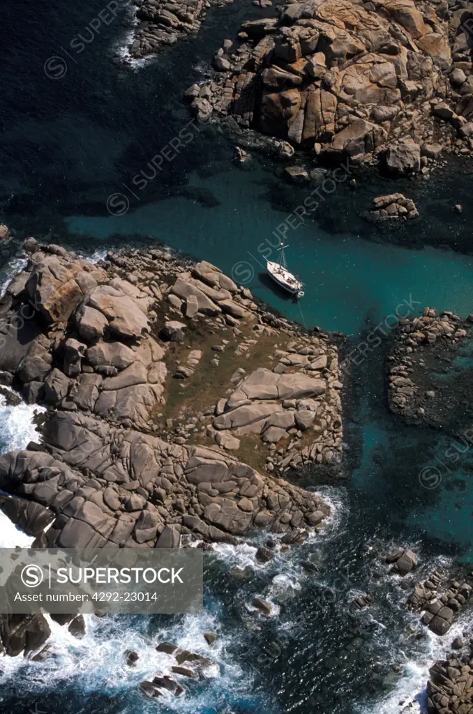 France, Corsica, boat moored in rocks near Bonifacio
