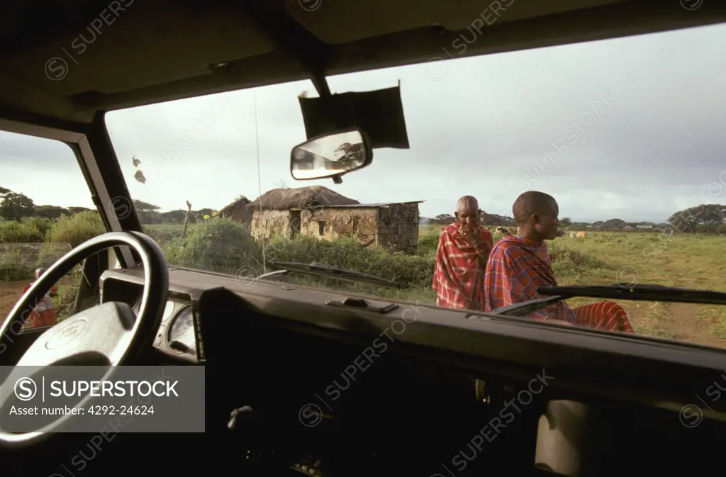 Africa, Kenya: Masai men seen from inside an off road vehicle