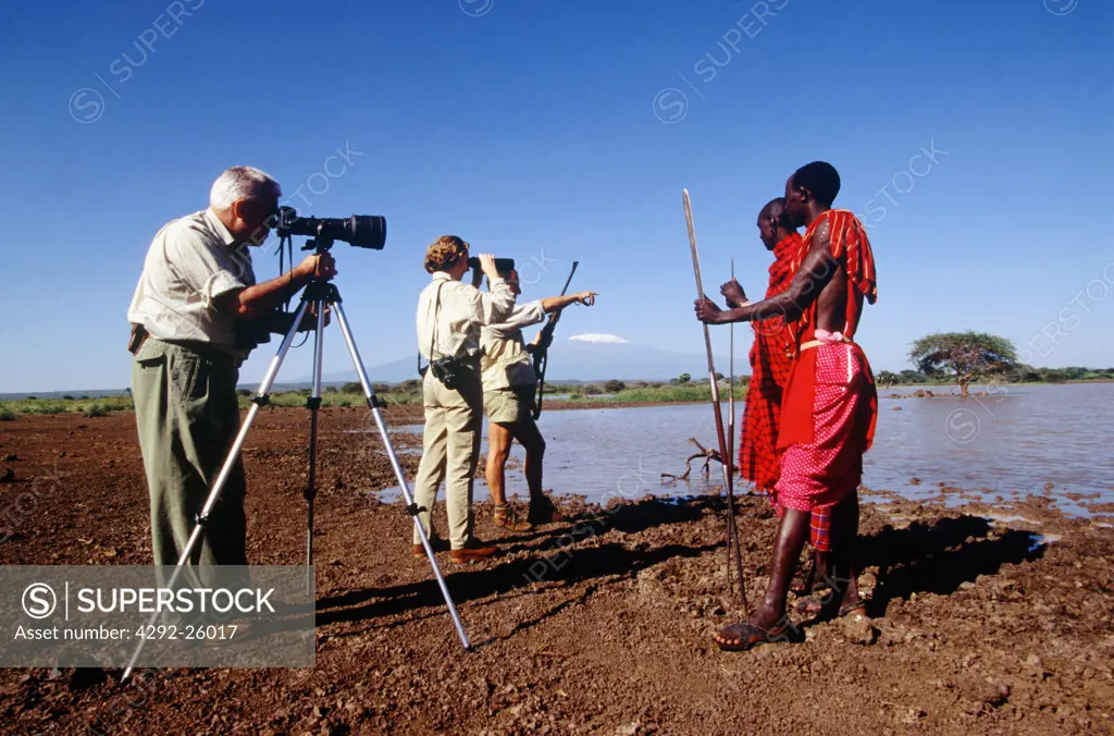 Africa, Kenya, tourist photographing Masai warriors