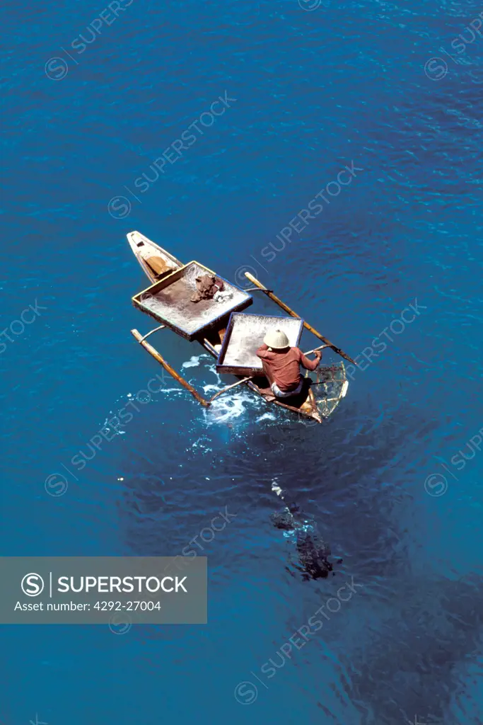 Malaysia, Sabah. Semporna Islands, Fisherman on canoe