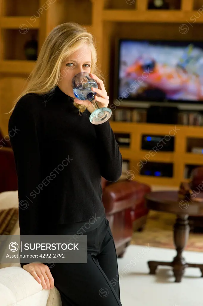 Woman in livingroom with a glass