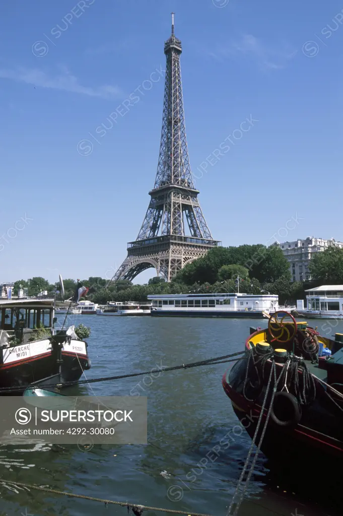 Eiffel Tower with river boats on Seine River Paris, Ile-de-France