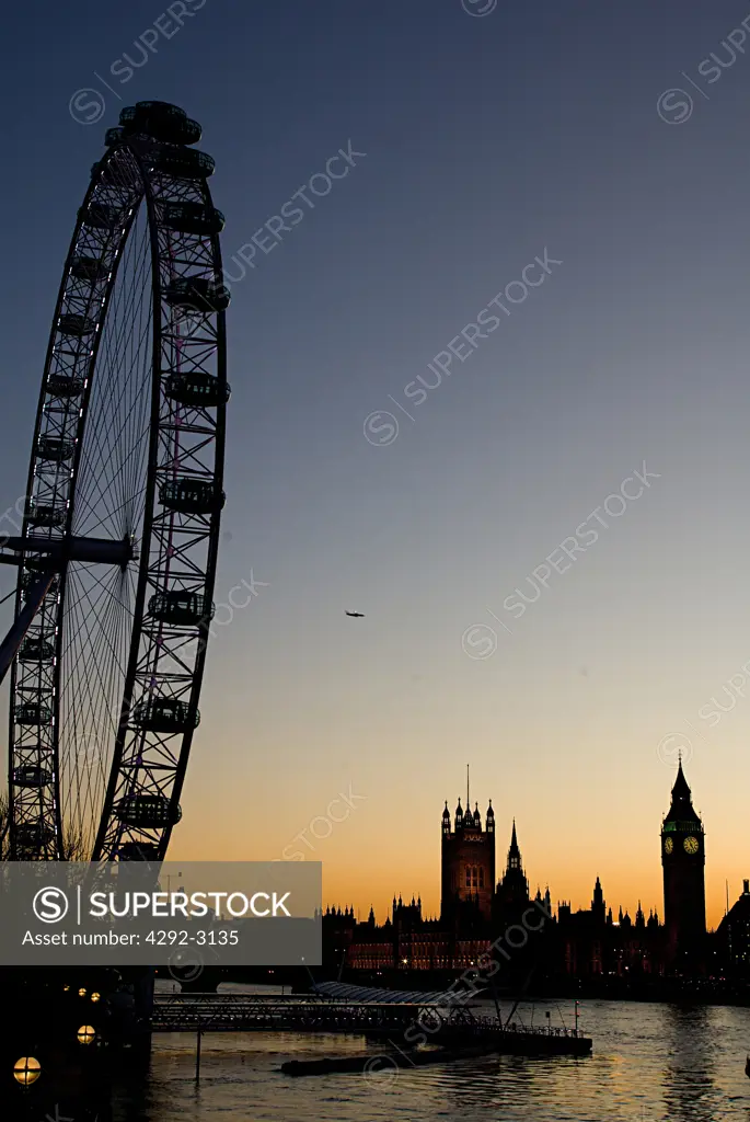 England, London, the London Eye at sunset with the Houses of Parliament in the background