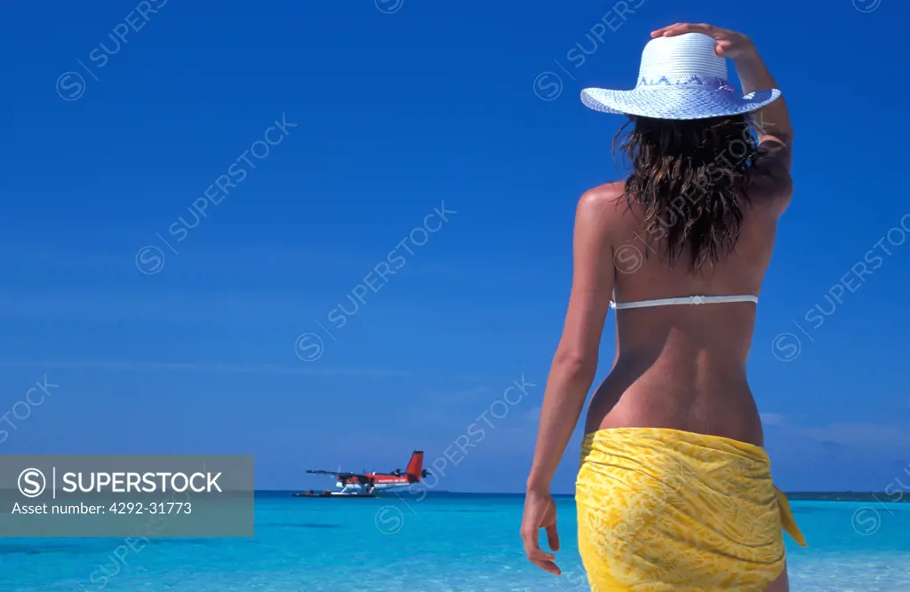 Maldives, Ari Atoll. White Sands Island. Woman on beach