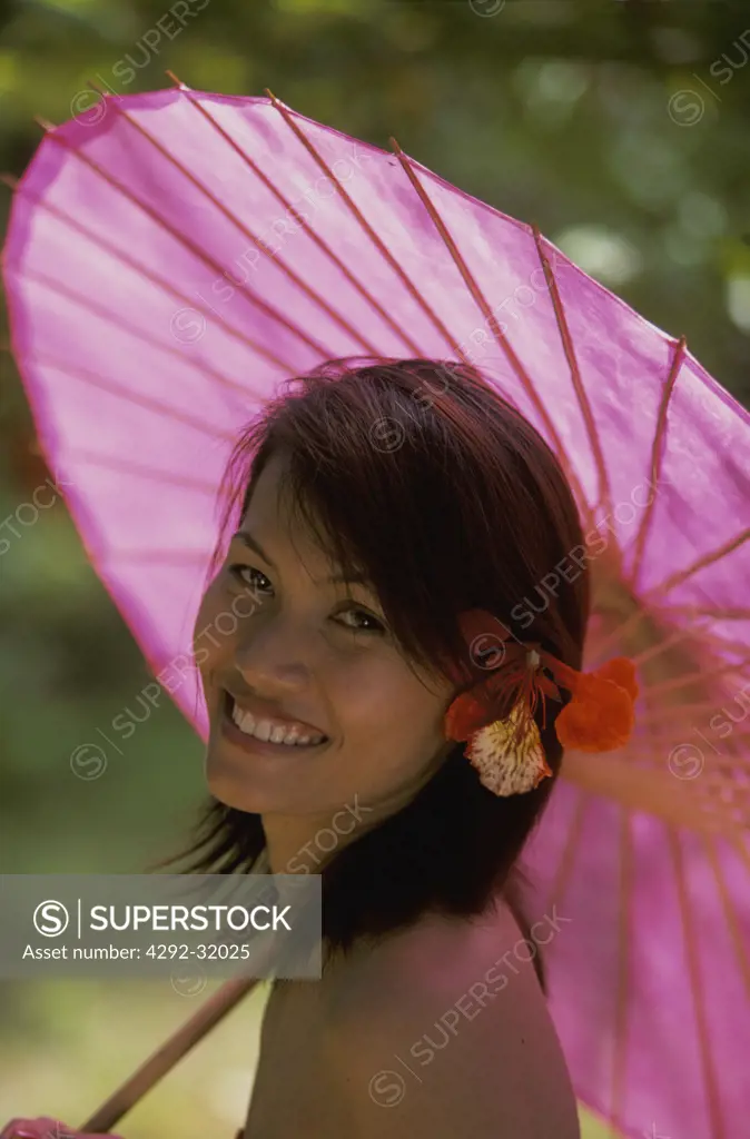 Thailand, Krabi. Thai woman with paper umbrella