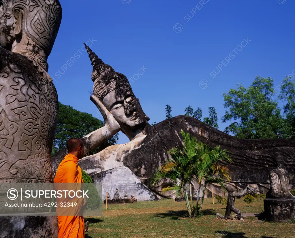 Asia, Laos, Vientiane, Monk at Giant Buddha of Wat Xieng Khuan