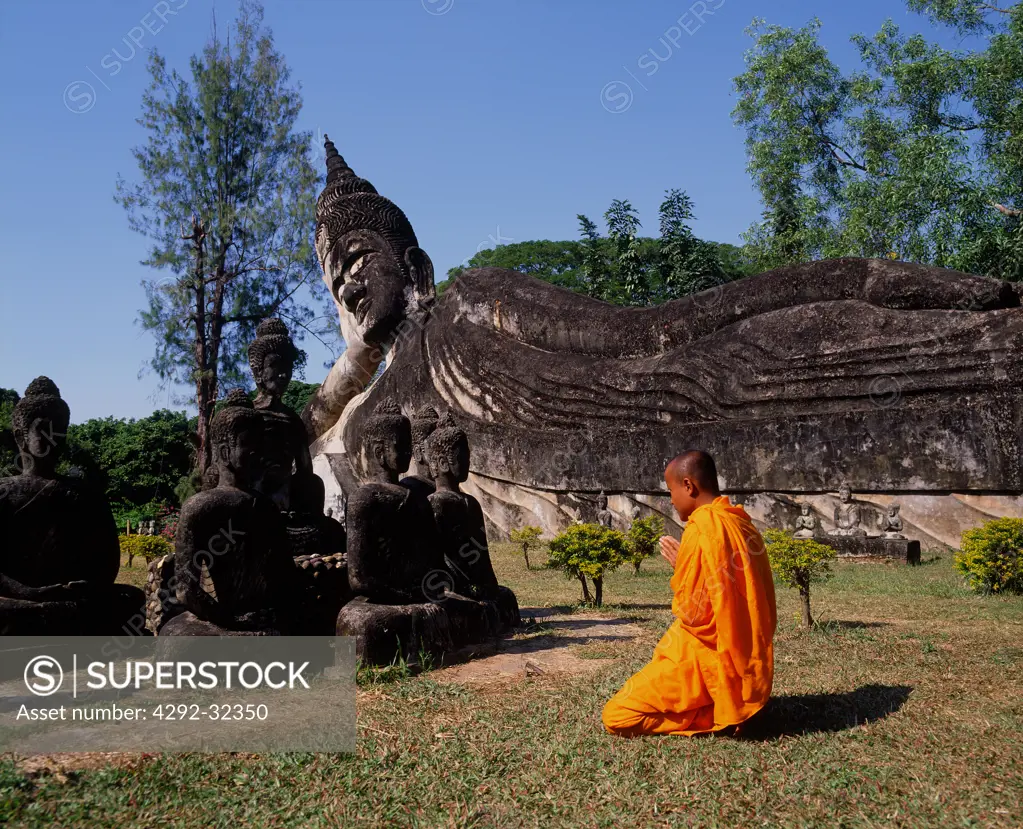 Asia, Laos, Vientiane, Monk at Giant Buddha of Wat Xieng Khuan