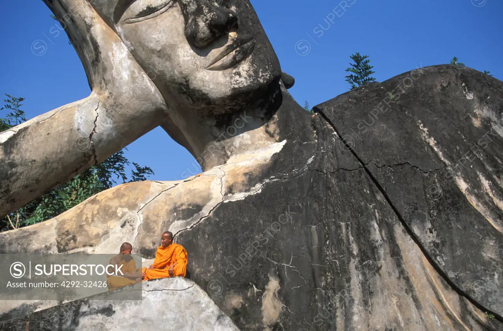Laos, Vientiane. Monks at the Giant Buddha of Wat Xieng Khuan