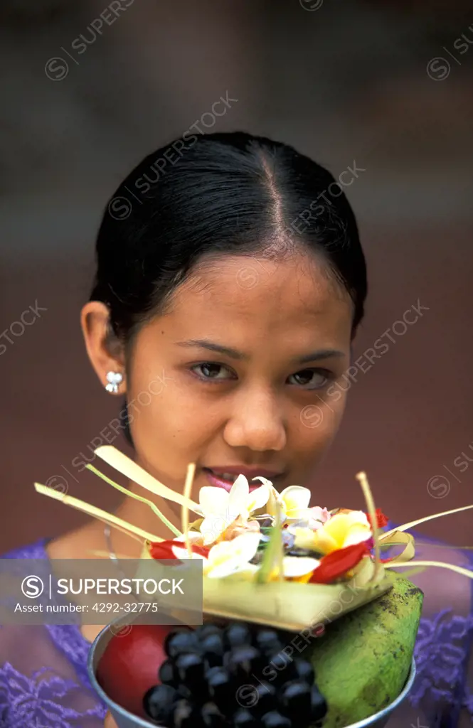 Indonesia, Bali, balinese woman making offering to Gods