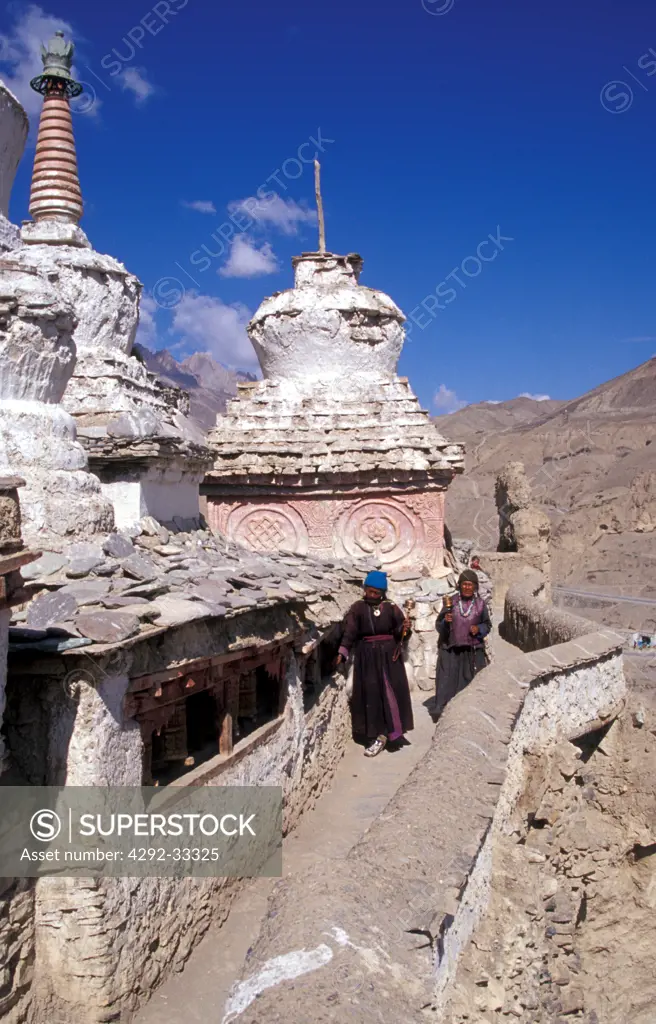 India, Jammu and Kashmir, Ladakh, Chortens Stupa, Lamayuru Monastery, woman at praying rolls
