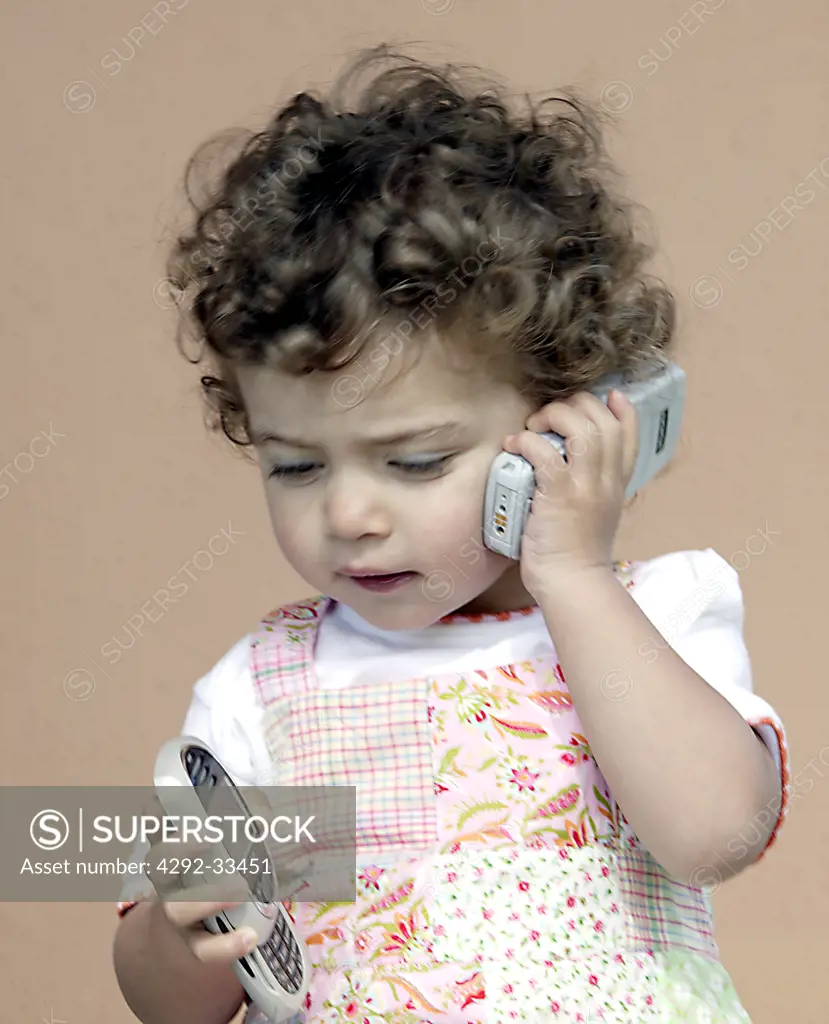 Little girl with mobile phones