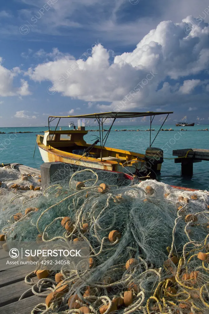 Aruba, Oranjestad harbour, fishing boats and nets on pier