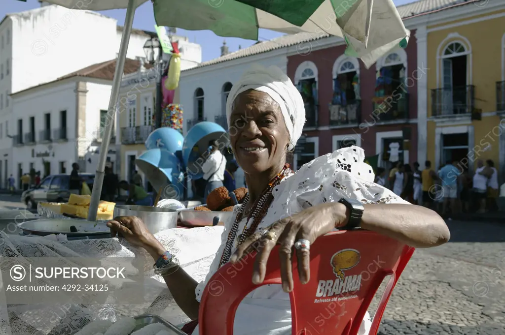 Brazil. Bahia. Salvador de Bahia. Pelourinho historical district.Bahia Woman with typical Bahia costume selling food