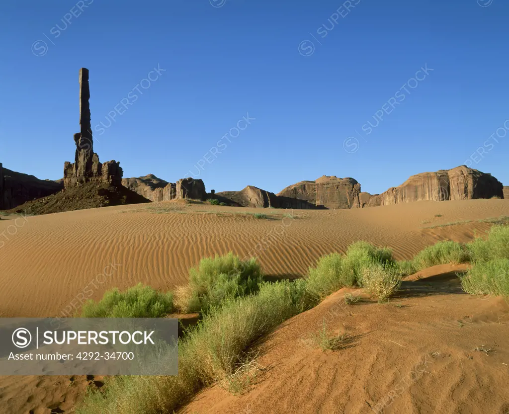 USA, Arizona, Moument Valley Navajo Tribal Park. Sand dunes and rock formations of Totem Pole