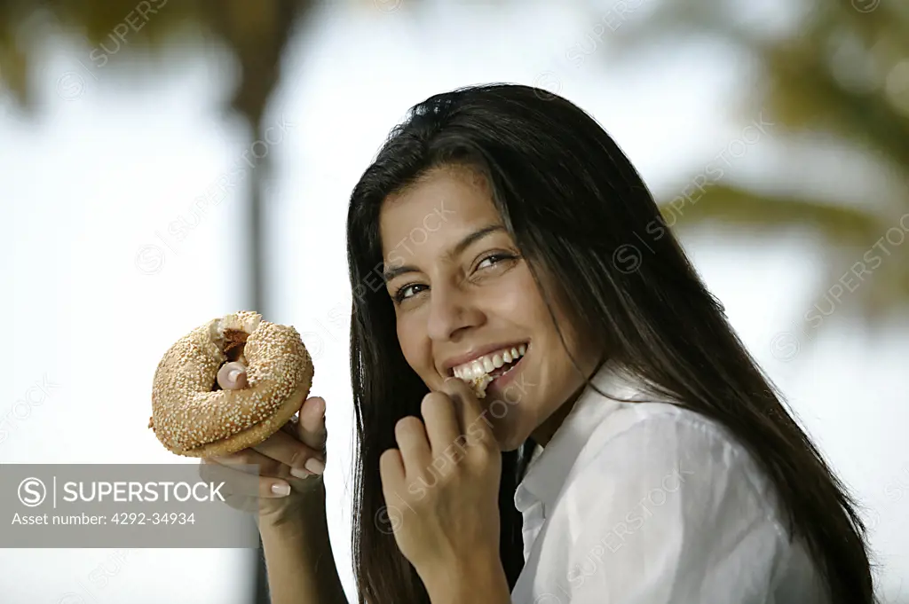 Playful woman eating a donughts