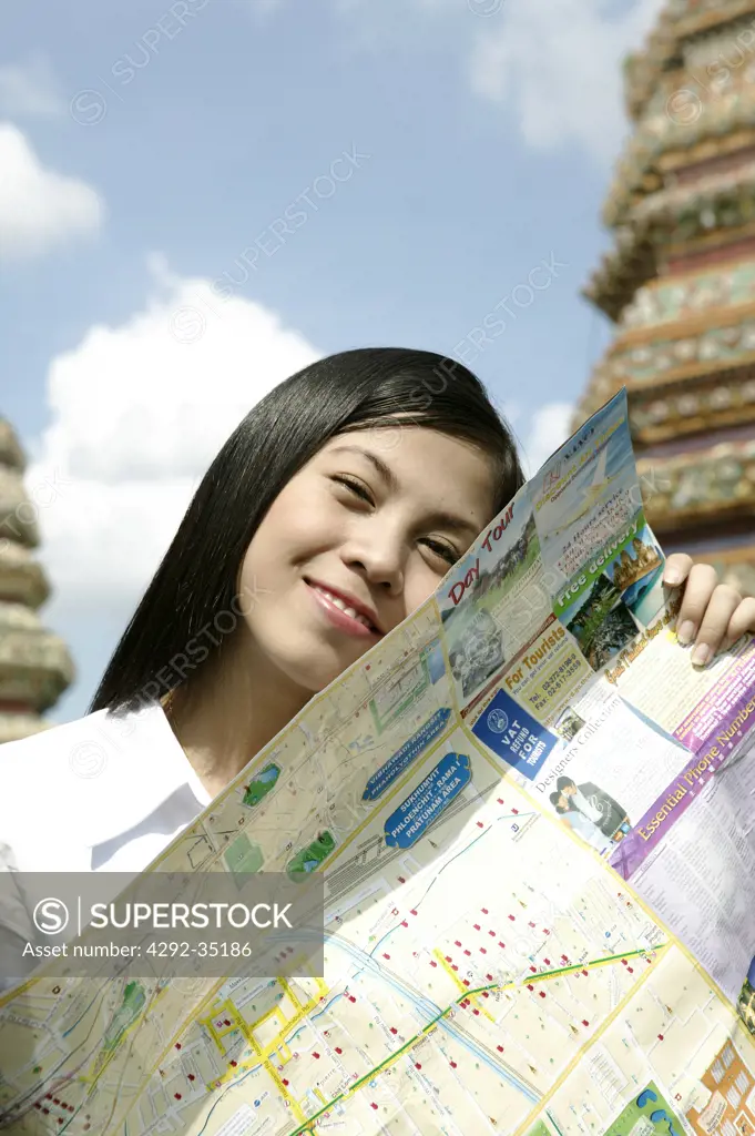 Thailand, Bangkok, Temple Wat Pho. Thai woman with map of Bangkok