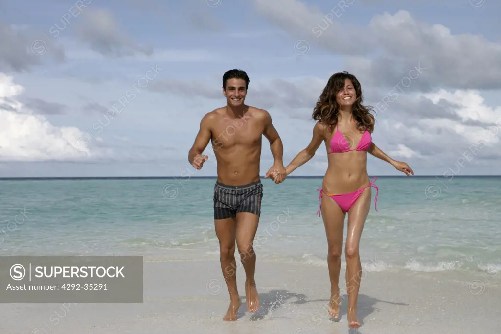 Couple runnning on beach