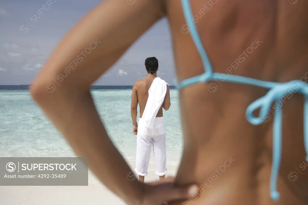 Rear view of couple at seaside