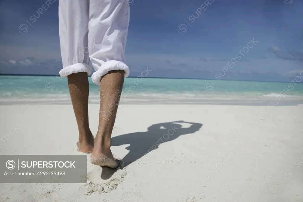 Man's legs on the beach