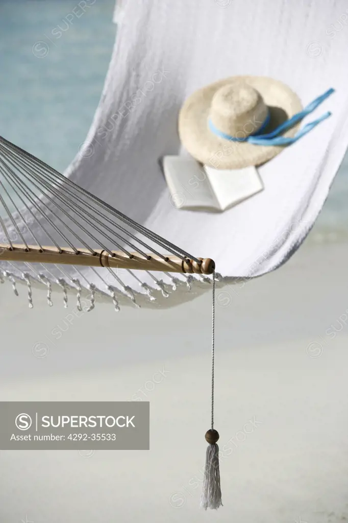 Straw hat and book on hammock