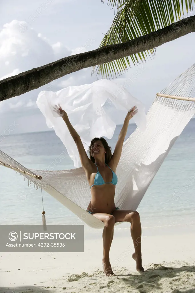 Woman sitting on hammock