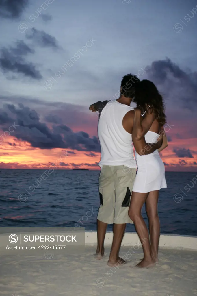 Couple embracing at sunset