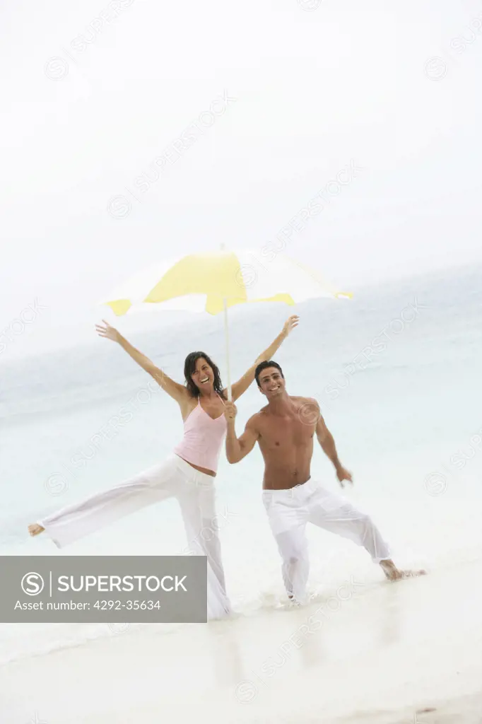 Playful couple standing on the beach