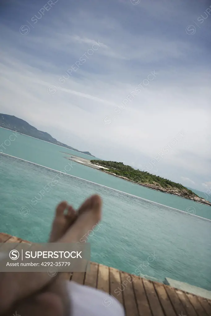Man's feet realxing at seaside, Thailand, Koh Samui Island