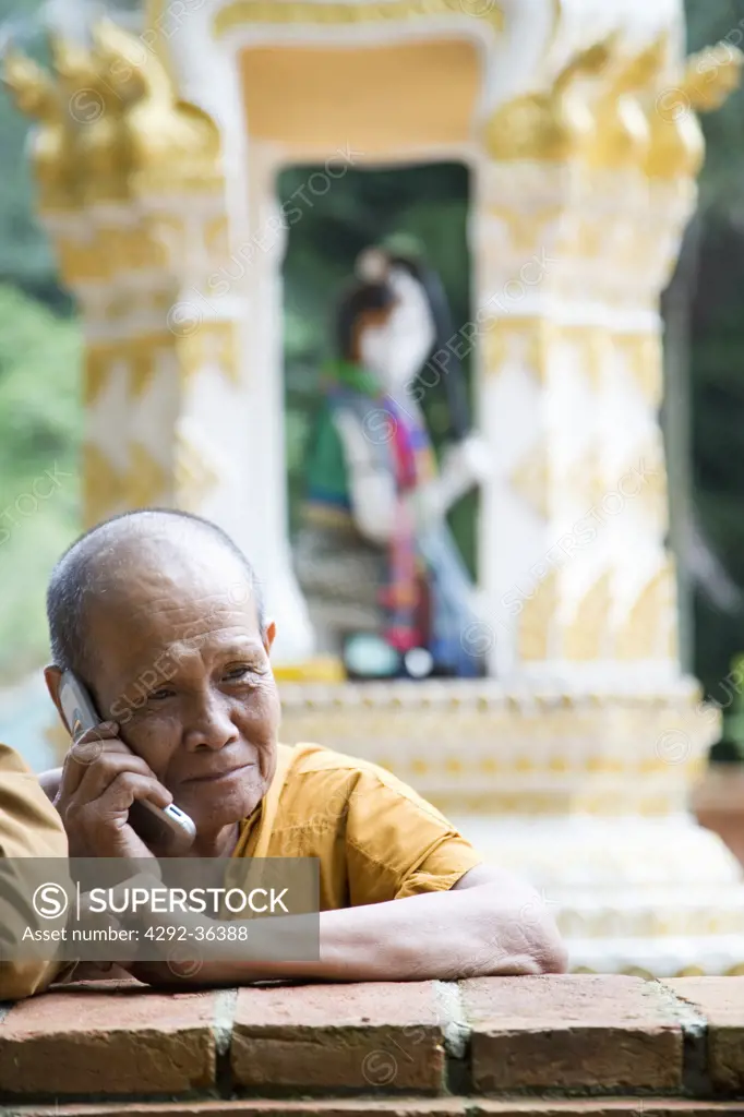 Thailand. Chiang Mai. Buddhist Temple Wat Phra Doisthep. Thai Buddhist Monk with cell phone (no property release)