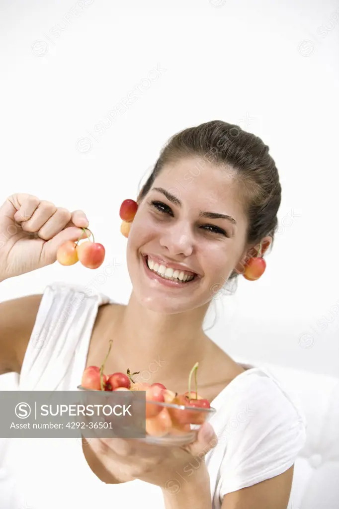 Young woman with bowl of cherries