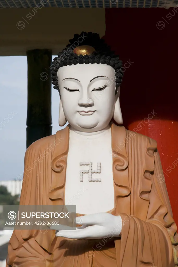 Malaysia, Penang. Kek Lok Si, buddhist Temple: close up of a Buddha statue