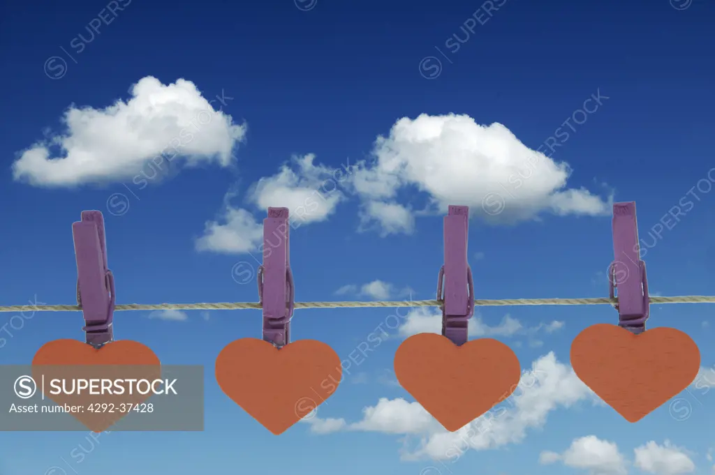Heart-shaped clothespins on clothesline