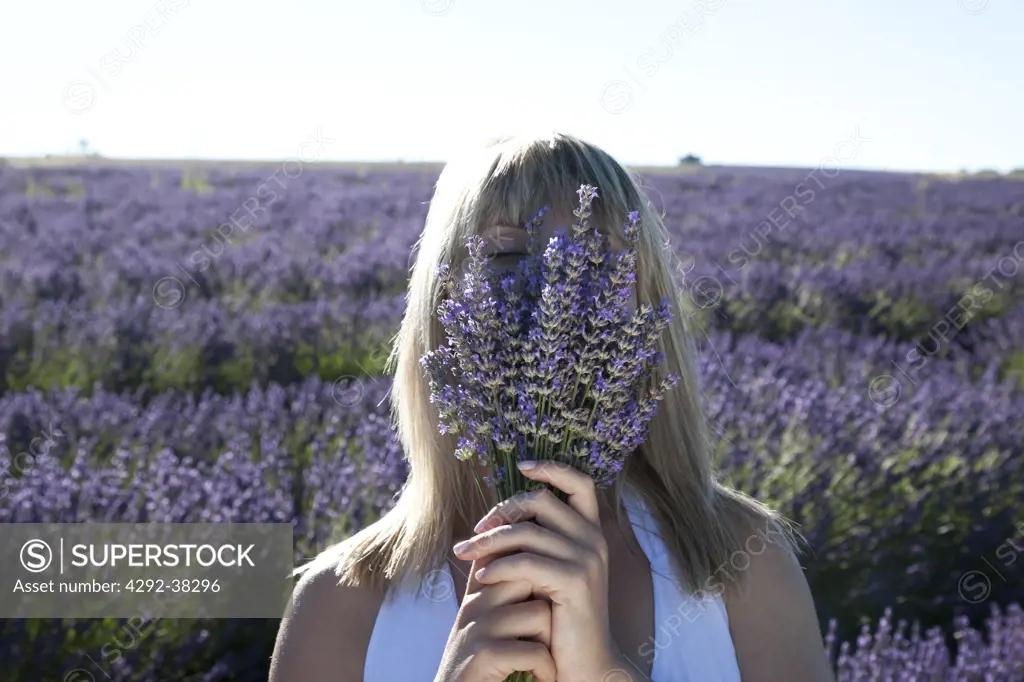 Woman smelling the perfume of lavender