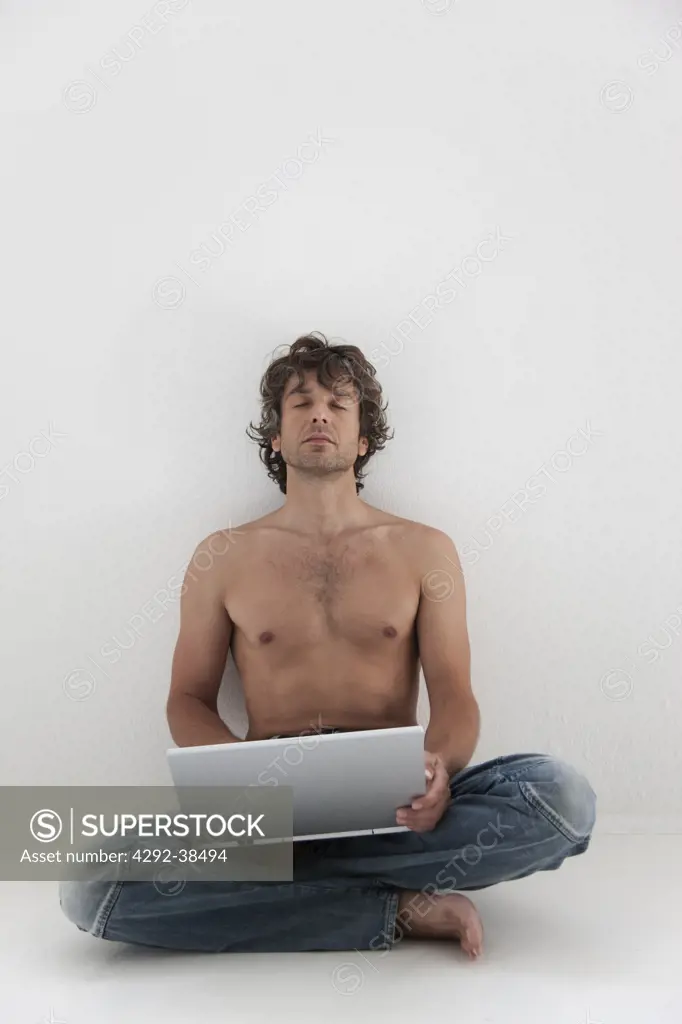 Studio shot of man with laptop