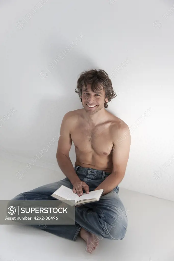 Studio shot of man reading a book