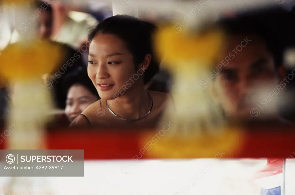 Girl on the ferry, reflected in the mirror of the conductor, Bangkok Thailand