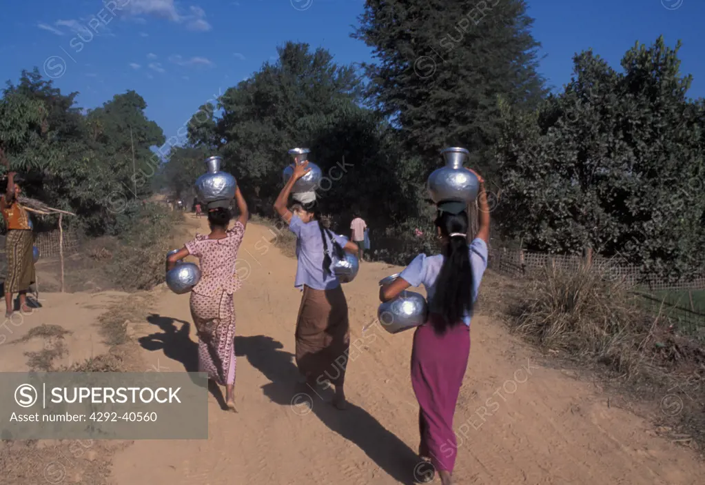 Burma, Arakan, women with metal jars on their heads