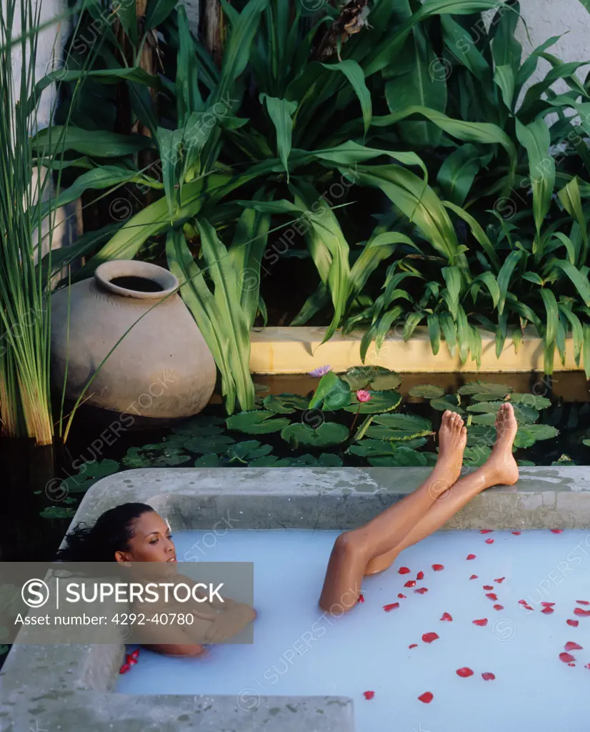 Thailand, Pranburi, Evason resort and spa, woman taking a milk bath