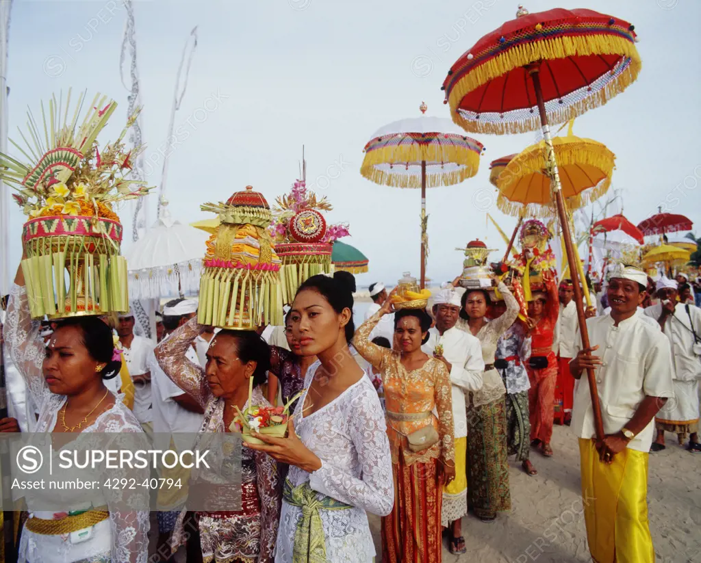 Balinese girl with offering during a ceremony, Bali, Indonesia