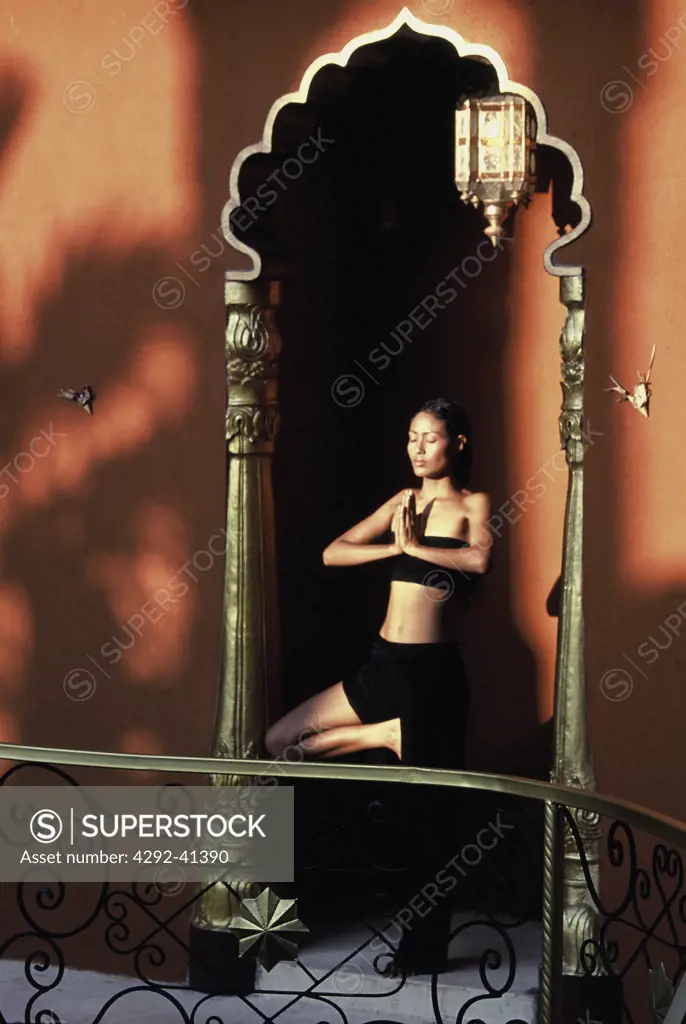 Asian woman practising yoga