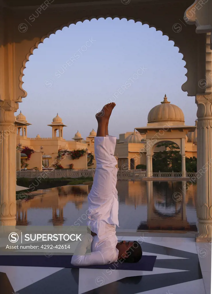 India, Udaipur, Rajastan,Uberoi Udai Vilas Hotel, man doing yoga