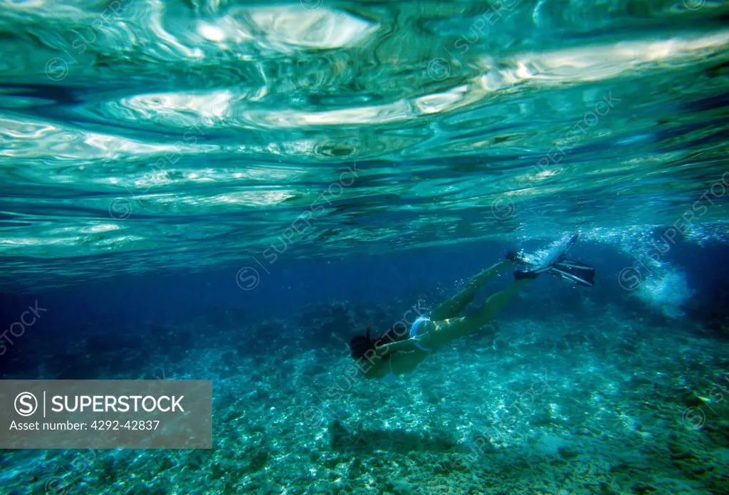 Woman snorkeling in Maldives, underwater view